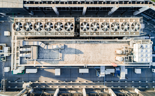 Aerial top down view of ventilation and air conditioning systems installed on the rooftop of a skyscraper in a developed business district © Евгений Бахчев