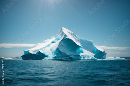 A beautiful ice iceberg on a blue ocean against a blue sky background.