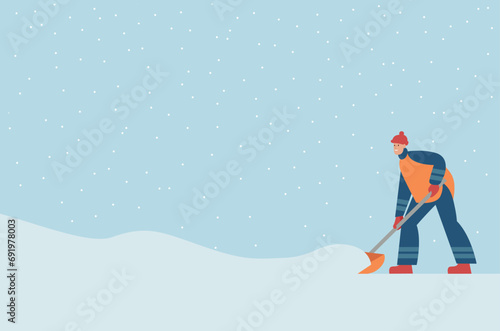 Man removing snow with shovels. Worker in uniform cleaning city street after snowstorm.