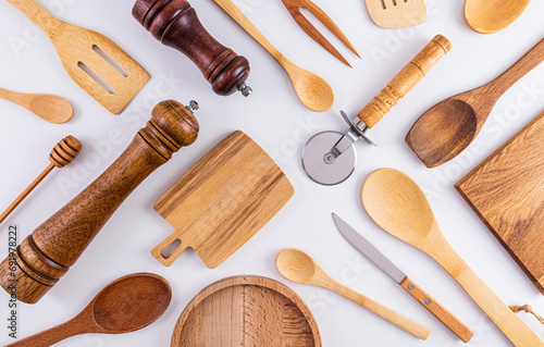 Lots of different wooden kitchen tools for cooking on white background. Top view. Flat layout. Eco items. zero waste.