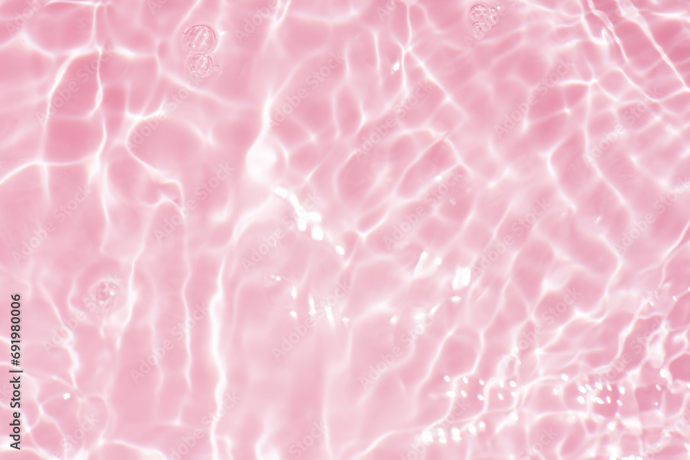 Pink water bubbles on the surface ripples. Defocus blurred transparent pink colored clear calm water surface texture with splash and bubbles. Water waves with shining pattern texture background Pink water bubbles on the surface ripples. Defocus blurred transparent pink colored clear calm water surface texture with splash and bubbles. Water waves with shining pattern texture background
