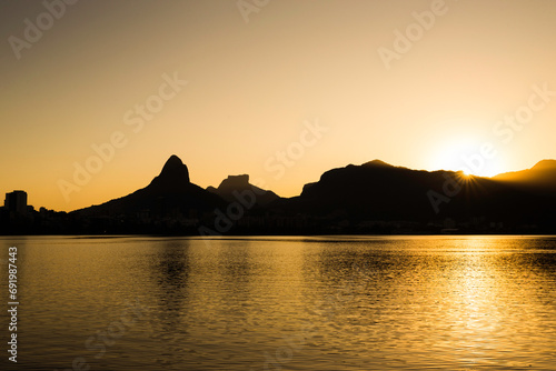 Beautiful View of Rio de Janeiro Sunset Behind Mountains at Rodrigo de Freitas Lake photo