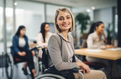 an employee sitting in a wheel chair while others are in an office