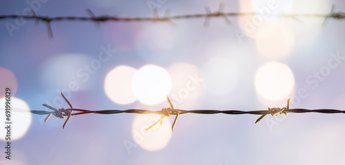 Barbed wire fence with sunset Twilight sky. photo