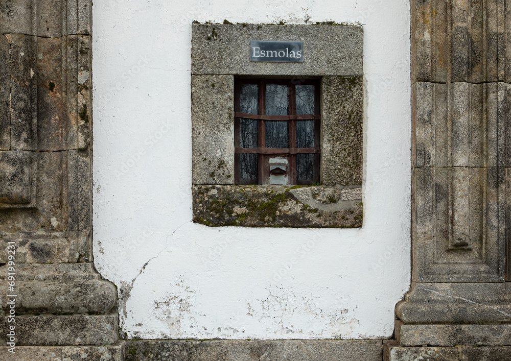 Church front facade with small window for donation or alms, esmolas in portuguese Church front facade with small window for donation or alms, esmolas in portuguese
