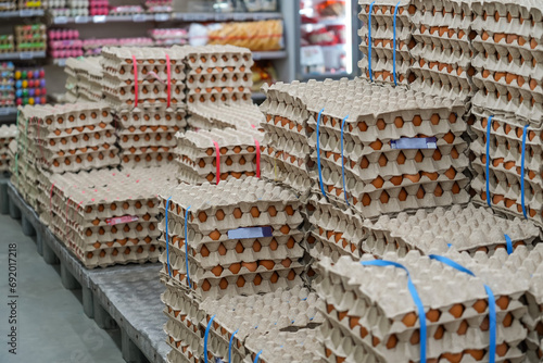 Many stacks of rows and paper packaging for chicken eggs, stacked in a store, brought from poultry farms in rural areas for sale in city stores photo