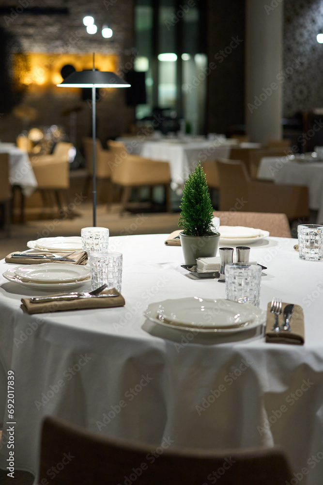 Restaurant table with cutlery and christmas tree. Restaurant table with cutlery and christmas tree.