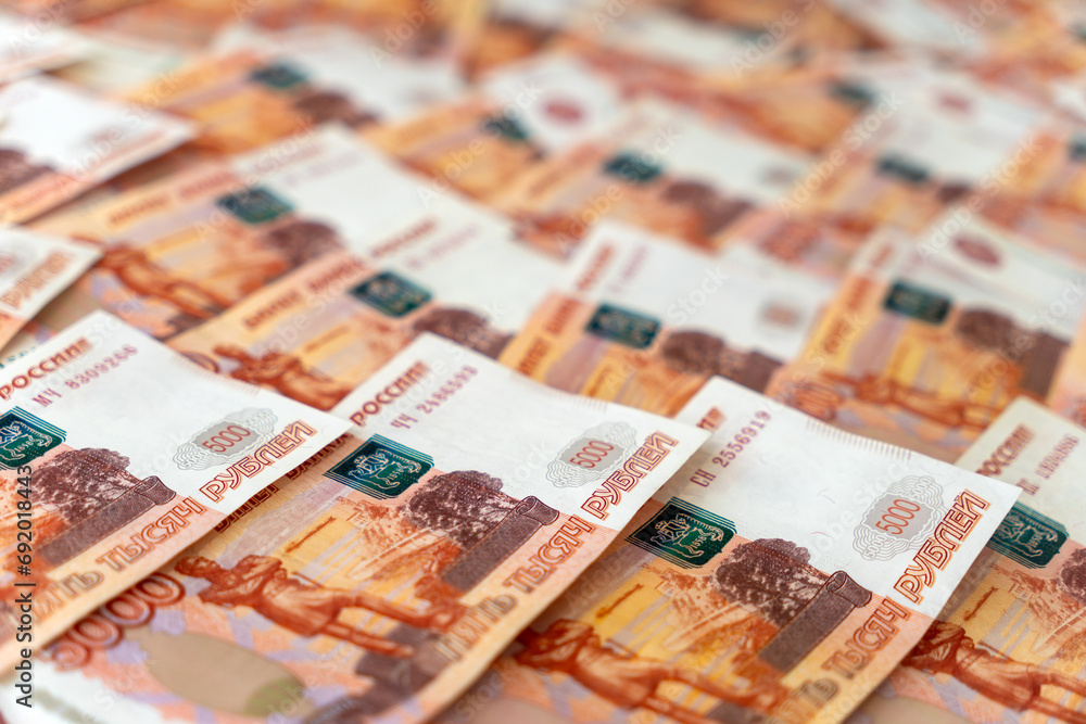 Top view of many scattered banknotes 5000 ruble notes on table. Exchange currency concept. Background of five thousand russian rubles banknotes, one million cash money. Top view of many scattered banknotes 5000 ruble notes on table. Exchange currency concept. Background of five thousand russian rubles banknotes, one million cash money.