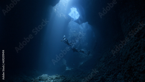 SCUBA Divers explore an underwater cavern © Lightning Strike Pro