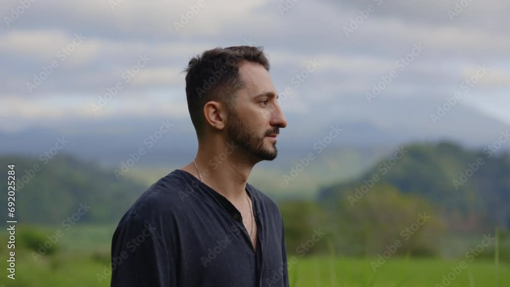 Smiling Multiracial Man Standing Outside in the Mountains, Posing to the Camera. Portrait of the Happy Guy Outdoors Feeling Free after Retreat. Tourism and Traveling Concept. Smiling Multiracial Man Standing Outside in the Mountains, Posing to the Camera. Portrait of the Happy Guy Outdoors Feeling Free after Retreat. Tourism and Traveling Concept.