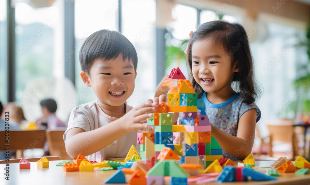 Asian Children Create Colorful Structures with Building Blocks - Creativity and Joyful Play. Asian Children Create Colorful Structures with Building Blocks - Creativity and Joyful Play.