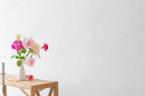 Wallpaper Mural pink and white roses in white ceramic vase on white background Torontodigital.ca