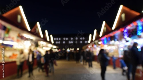 Families walking parents and children shopping at Christmas Market in the Plaza Mayor of Madrid Spain out of focus photo