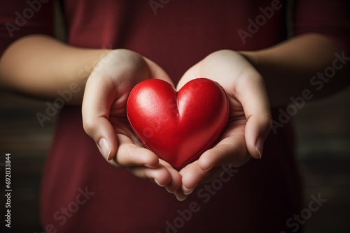 Hands holding red heart close up