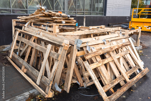 Stacked Wooden Planks and Dismantled Crate at Construction Area