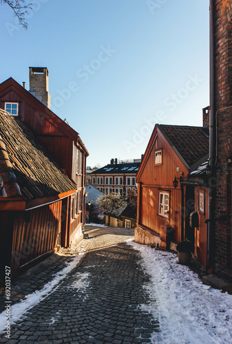 old houses in the city on warm end of winter day with snow on sunny morning  photo