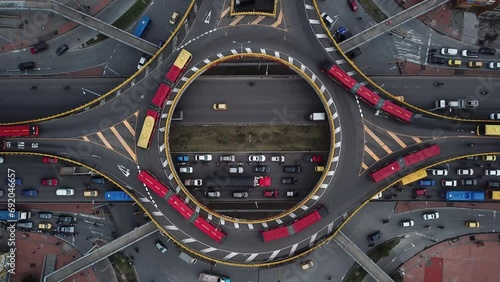 Aerial drone shot of Roundabouts in Bogota, Colombia, Latin America. Traffic in Bogota, Transmilenio. Dedicated busway on the top level. Famous roundabout full of red buses. High quality 4k footage. photo