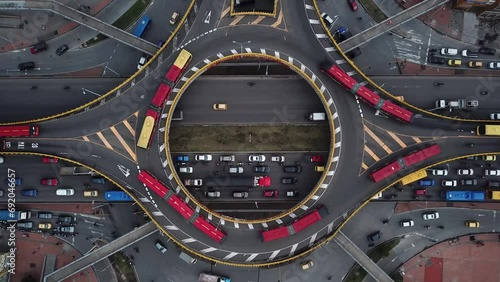 Aerial drone shot of Roundabouts in Bogota, Colombia, Latin America. Traffic in Bogota, Transmilenio. Dedicated busway on the top level. Famous roundabout full of red buses. High quality 4k footage.