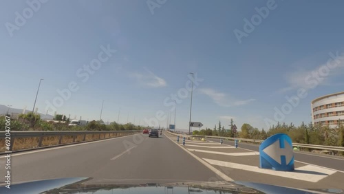 First person view, FPV, from dashcam of car driving towards Madrid from Granada in Andalusia, Sierra Nevada Mountains, Spain, Europe. Road trip video in POV, with bright, sunny, blue sky photo