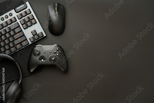 Gaming concept on black background with computer keyboard and joystick photo