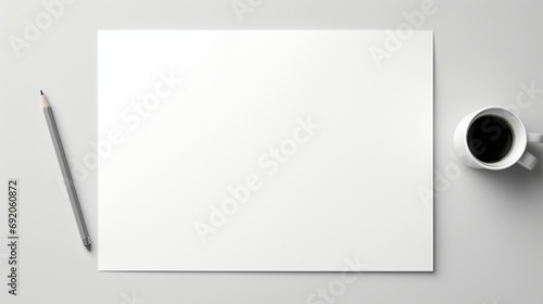 Pencil and blank paper on a desktop, seen from above .