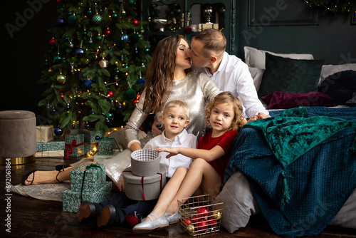 father  mother and children boy and girl having good time on Christmas decorated home