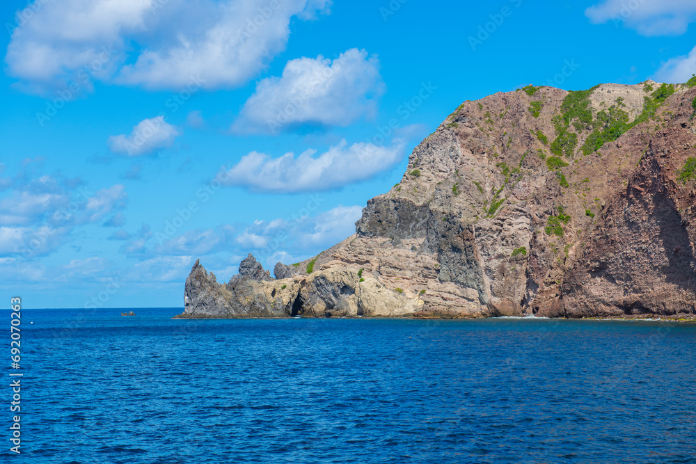 Well's Bay Beach with Cape Rhino at the end of the cliff on island of Saba, Caribbean Netherlands. 