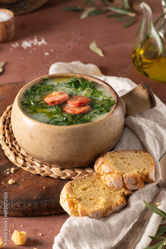 Caldo verde popular soup in Portuguese cuisine. Traditional ingredients for caldo verde are potatoes, onion, garlic, collard greens, chorizo , olive oil and salt. Is a comfort soup
