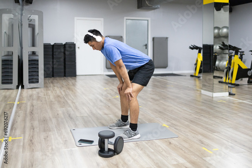 Man resting after workout in modern gym