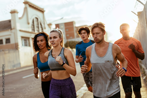 Group of young people running through the city photo