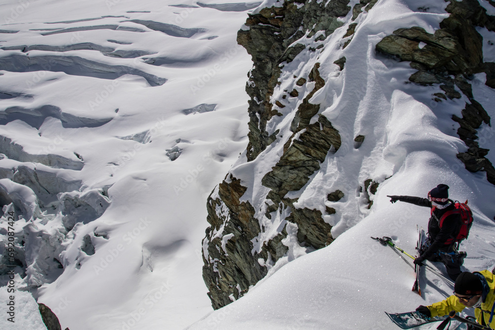 From above of unrecognizable skiers resting on mountain while admiring majestic snowy landscape in Zermatt From above of unrecognizable skiers resting on mountain while admiring majestic snowy landscape in Zermatt