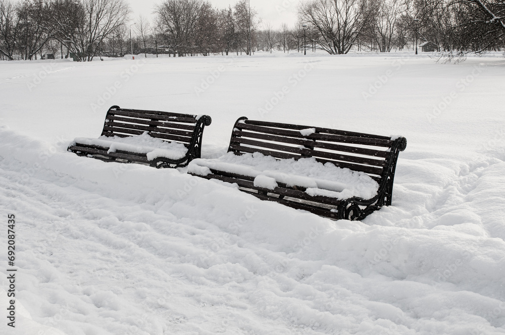 Park benches covered snow in winter park