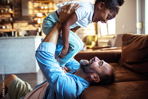 Father having fun with little daughter at home