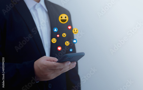 Man uses smartphone to rate satisfaction with online service, satisfaction concept Taking an online assessment