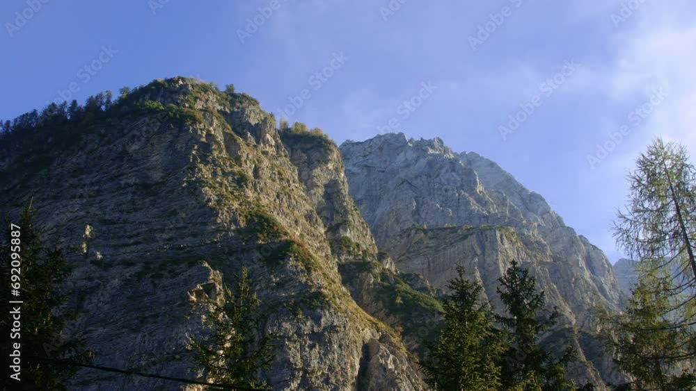Majestic Alpine mountain peaks with lush greenery under a clear blue sky. Majestic Alpine mountain peaks with lush greenery under a clear blue sky.