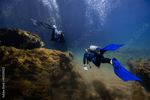 Scuba divers exploring Cancun's mangrove underwater photo