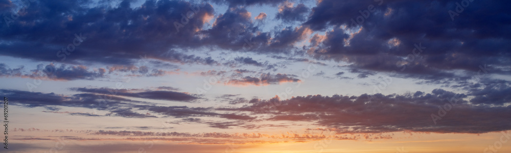 Fototapeta premium Sunset sky with clouds. Blue and yellow natural background