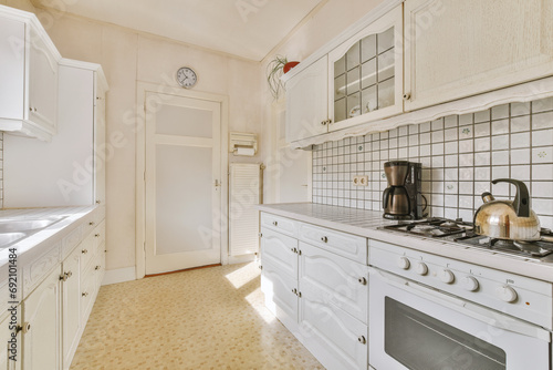 Bright white kitchen of modern home photo