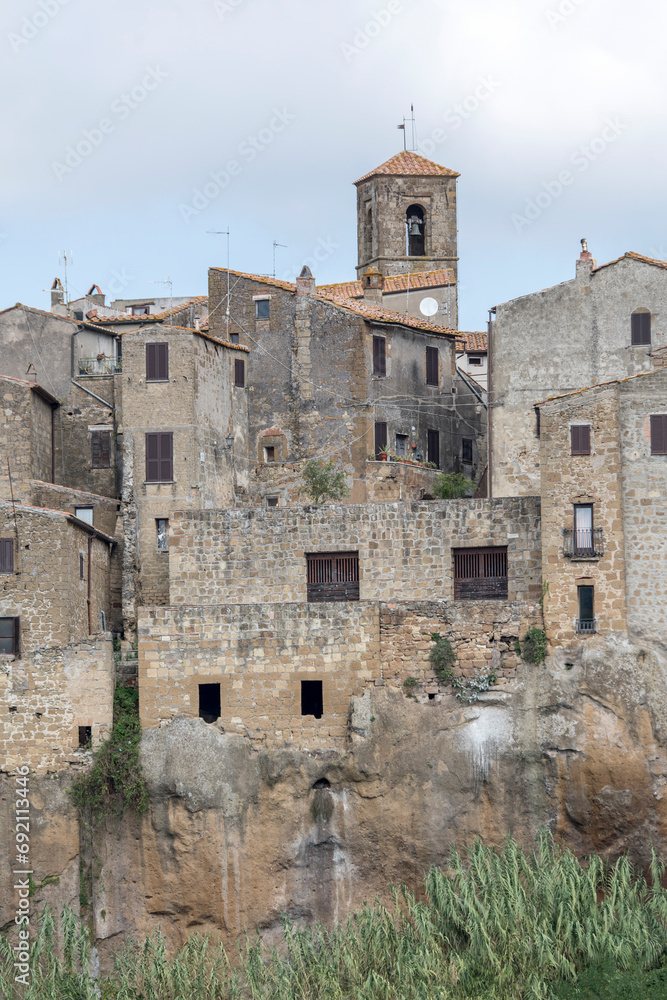 san Rocco bell tower and medieval houses on cliffs, Pitigliano, Italy