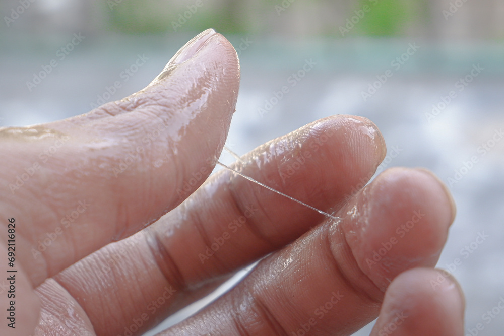 Fototapeta premium adult hands wet with mucus.