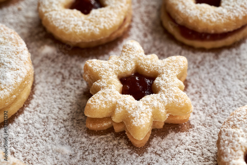 Homemade star shaped Linzer Christmas cookie on a table