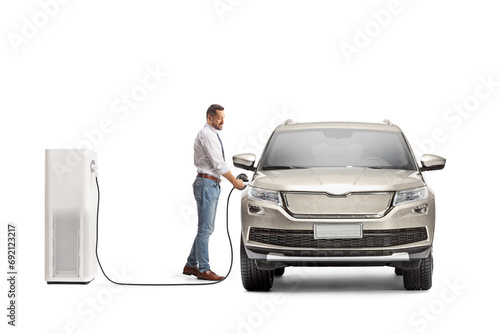 Man plugging a SUV at an electric charging station photo