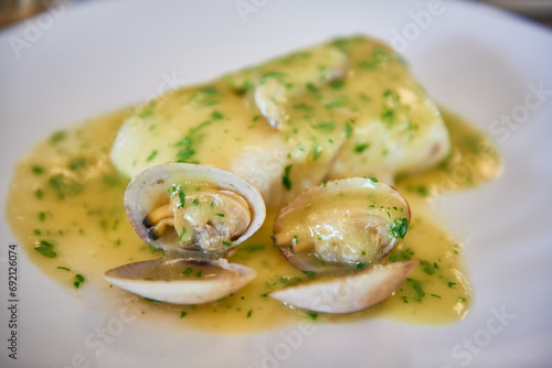 View of the typical basque country dish, Hake with Clams and Kokotxas and Pil-Pil sauce.