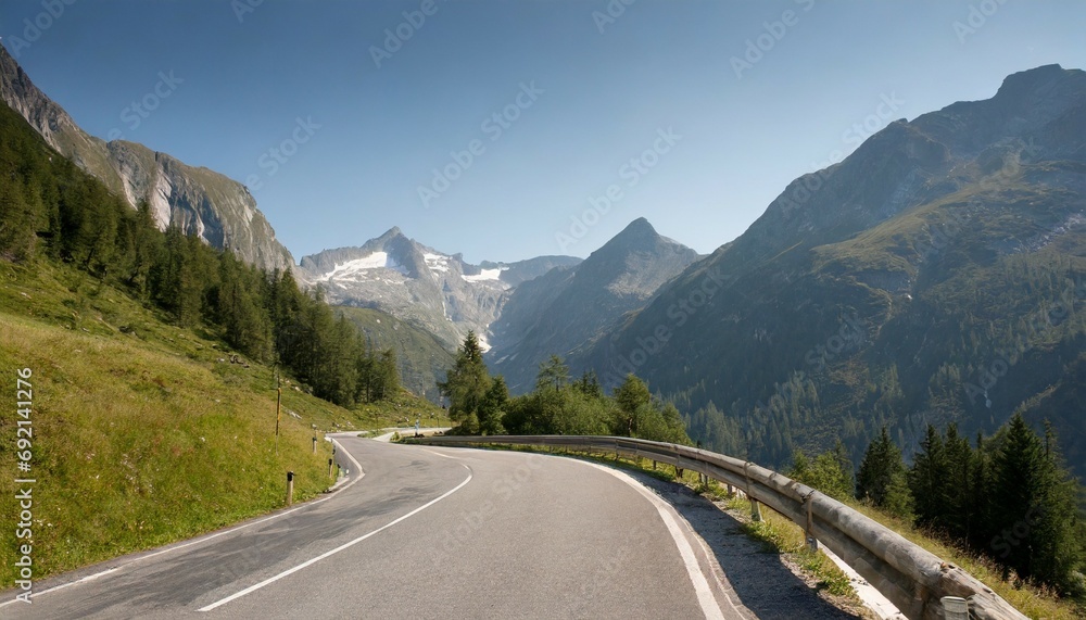 asphalt road in austria alps in a summer day