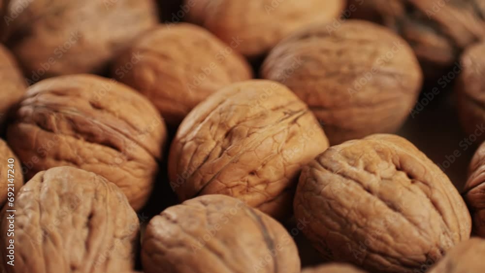 Walnuts in a shell rotating top view. Healthy snacks. Product rich in minerals and vitamins. Walnuts in a shell rotating top view. Healthy snacks. Product rich in minerals and vitamins.