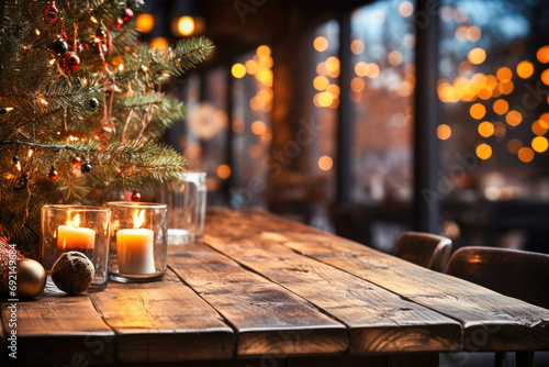Wooden table with decorated Christmas tree on the background of holiday lights