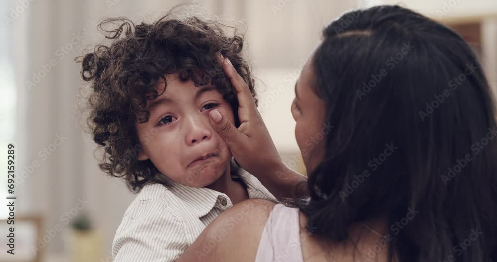 Sad, child and mother wipe tears, care and love of family bonding together in home. Crying, boy and mom comfort, console and emotional support of angry, frustrated or tired young kid in pain at house Sad, child and mother wipe tears, care and love of family bonding together in home. Crying, boy and mom comfort, console and emotional support of angry, frustrated or tired young kid in pain at house