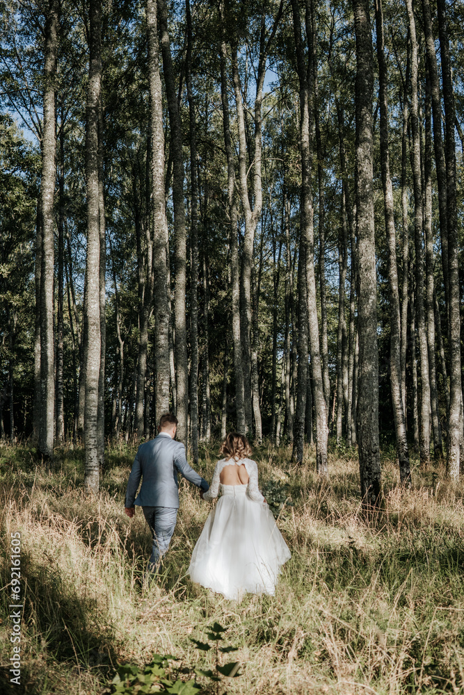 Affectionate Newlywed Couple Celebrating Their Wedding Day in a Beautiful Forest Affectionate Newlywed Couple Celebrating Their Wedding Day in a Beautiful Forest