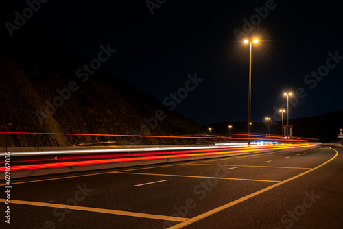 Mountain Glow: Khor Fakkan Highway Light Trails in the Dark photo