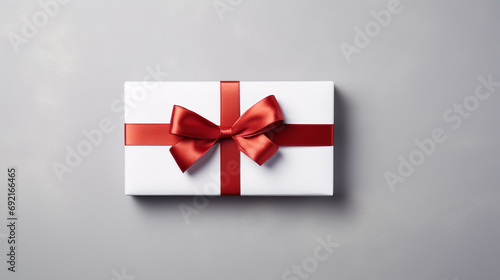 White present box with red bow isolated against grey backdrop, AI Generated